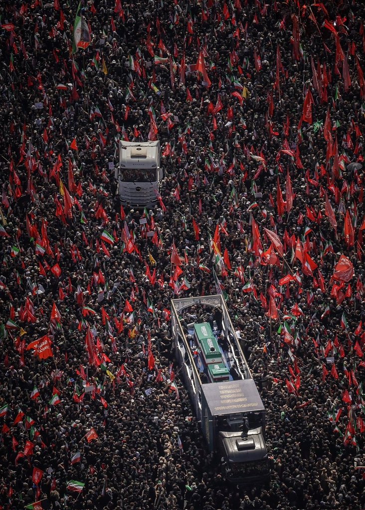 The coffin amid a crowd of millions